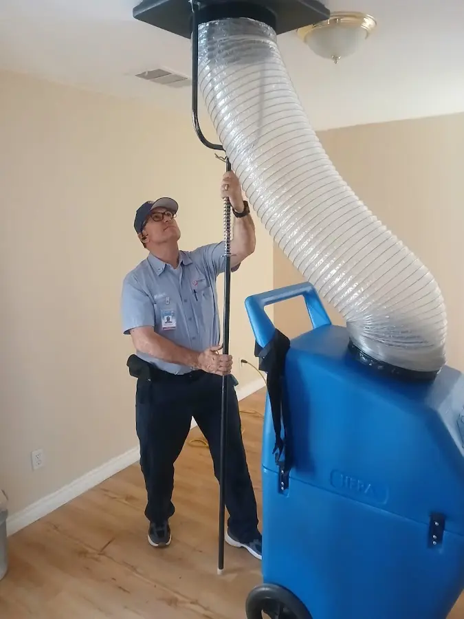 Furnace Tune-Up technician using HEPA equipment in Marina